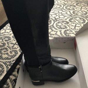 Black leather boots with gold accents